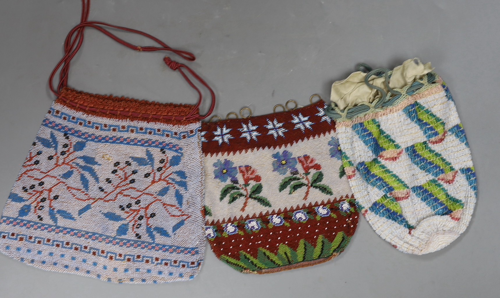 A 19th century bead worked bag with sailing ship design, a similar floral bead worked bag and a 1920’s-30’s abstract bead worked bag